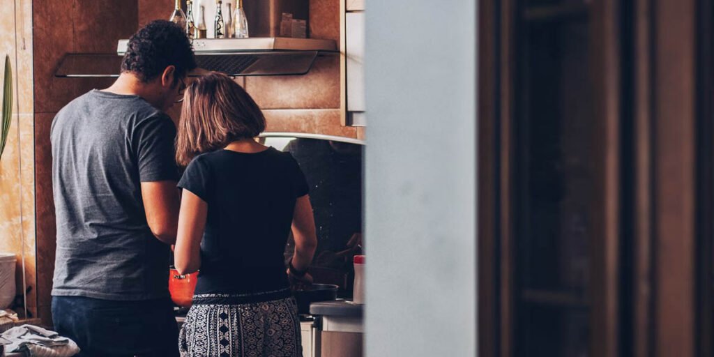 young couple cooking homemade dog food together